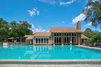 Resort style swimming pool with clubhouse in background